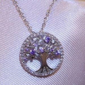 Elegant Tree of Life necklace with purple cubic zirconia on a polished silver chain