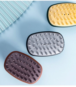 Three silicone scalp massagers in yellow, gray, and brown showing conical bristles