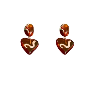 Elegant amber heart earrings with white wave patterns and silver needle studs