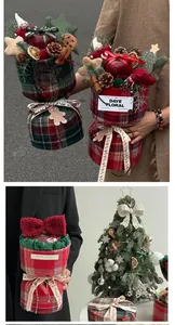 Close-up of Christmas British plaid fabric wrap with pine cones and cinnamon sticks