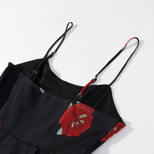 Detail of black floral off-shoulder dress with red flower print and adjustable straps