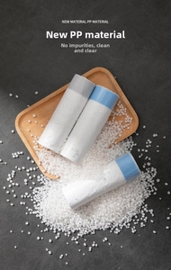 Detail of drawstring trash bags with PP raw material granules on wooden tray background