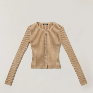 Detail of khaki ribbed knit cardigan showing vertical texture and brand label