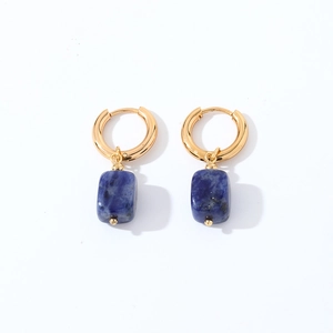 Detailed macro view of geometric gold hoops with rectangular deep blue natural stone pendants