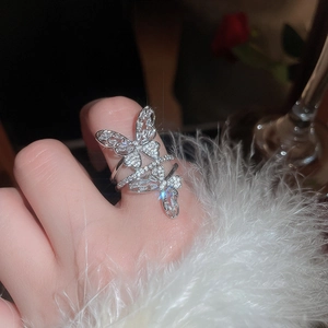 Close-up of sparkling silver double butterfly open ring with cubic zirconia on model