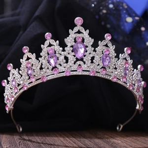 Close-up of sparkling purple crystals and rhinestones on a silver leaf-style bridal tiara