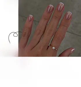 Close-up of classic French white tip press-on nails with a nude pink base finish
