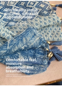 Detailed close-up of blue feather pattern cotton scarf with beaded tassel accents