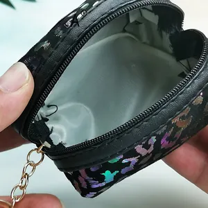 Close-up of the open heart-shaped coin purse with holographic leopard texture and lining