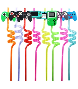 Colorful spiral reusable straws with vibrant game controller charms on white background