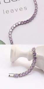 Macro view of purple cubic zirconia tennis bracelet with silver-tone prong setting detail