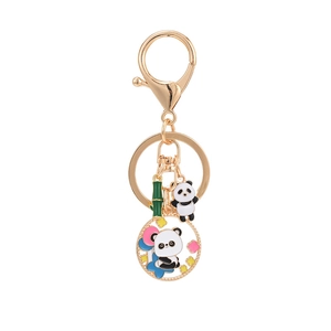 Cartoon panda keychain with bamboo charm in gold metal finish for bags and keys