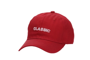 Detail of red cotton baseball cap with white CLASSIC embroidery and premium stitching