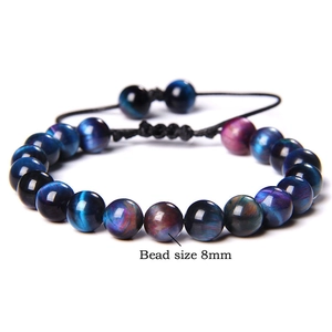 Macro shot of 8mm tiger eye stone beads on an adjustable braided woven bracelet