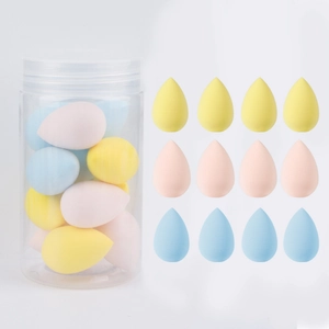 Macro detail of twelve multi-colored waterdrop makeup sponges in a transparent bucket container
