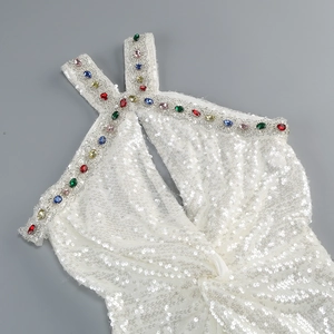 Detail of white sequin halter dress featuring colorful rhinestones on the neckline