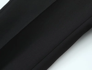 Macro detail of high-quality black plain weave fabric with elegant drape and texture