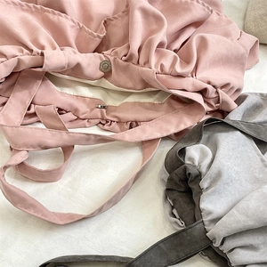 Detail of magnetic snap closure and soft lining on the pleated ruffled tote bag