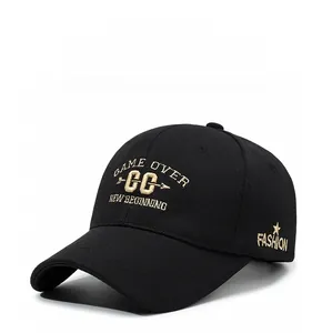 Detail of gold letter embroidery and star motifs on black cotton baseball cap