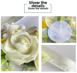 Detail of cream artificial rose wrist flower with satin ribbons and green leaves