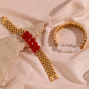 Detail of 13mm gold stainless steel watch band bracelets with red and white natural stones