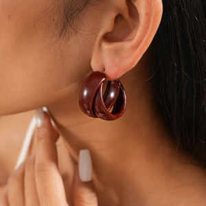 Close-up of deep red resin hoop earring on model showing elegant vintage texture