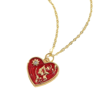 Golden heart pendant necklace with red enamel and leopard pattern detailing on white background