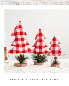 Close-up of three red plaid fabric Christmas tree ornaments with wooden bases