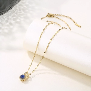 Golden reindeer necklace with blue color-changing zircon pendant and crystal accents
