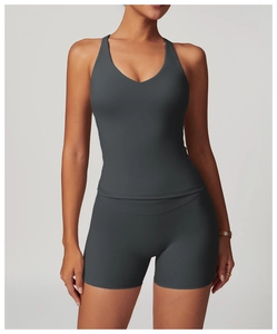 Detail of dark grey criss-cross back yoga vest and high-waist fitness shorts set
