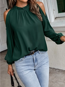 Detail of dark green cold-shoulder long sleeve top with elegant ruffled turtleneck design