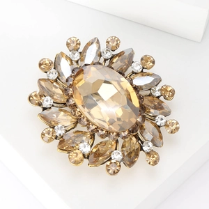 Detail view of retro brooch with champagne oval gemstone and crystal rhinestones