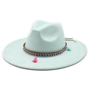 Detail of wide brim suede fedora featuring ethnic woven band and colorful tassels