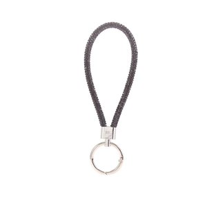 Close-up of black rhinestone-encrusted key ring strap with silver hardware detail