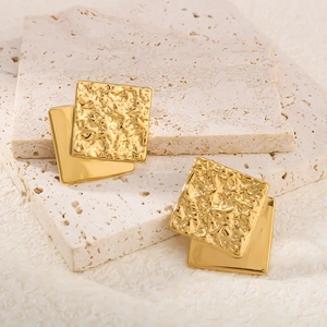 Detail of 18K gold-plated stainless steel square earrings with hammered texture