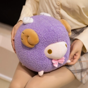 Cute purple sheep plush toy with wings and bowtie, shown held to illustrate size