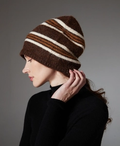 Side view of a striped wool knit beanie in brown, beige, and caramel on a model