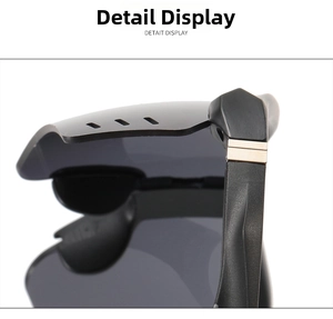 Detail of black cycling glasses showing matte frames and golden metal temple accents