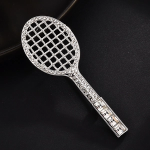 Detailed close-up of a silver tennis racket brooch with clear sparkling rhinestones