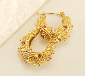 Close-up of 18K gold plated C-hoop earrings with woven texture and colorful zircon crystals