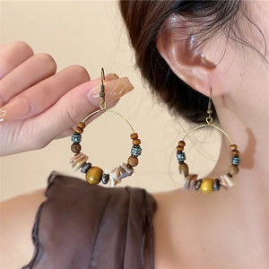 Bohemian shell bead tassel earrings with golden metal rings and wood accents