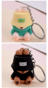 Close-up of PVC sleepy bear and rabbit keychains with fisherman hats and hoodies