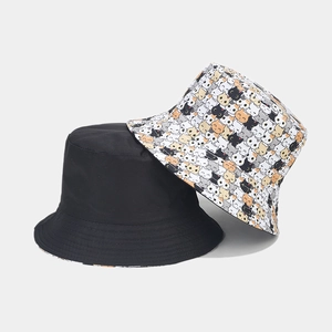 Detail of reversible bucket hat showing classic black and cartoon cat pattern prints