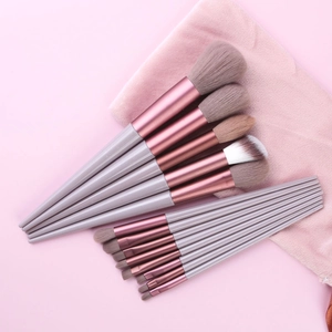 Professional 13pcs gray-purple makeup brush set with rose gold ferrules on pink fabric