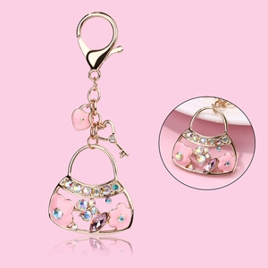 Pink enamel handbag keychain with gold plating, sparkling rhinestones and heart pendants