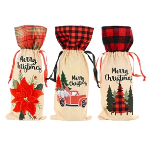 Three burlap Christmas wine bottle bags with poinsettia, red truck, and tree patterns