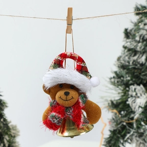 Detailed view of a plush Christmas bear ornament with a festive hat and golden metal bell
