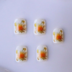 Short square press-on nails featuring white base and orange daisy floral patterns
