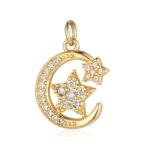 Macro detail of gold moon and stars pendant with sparkling cubic zirconia inlay