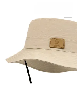 Detail of water-resistant sun hat fabric with SmileSide leather patch and wind rope